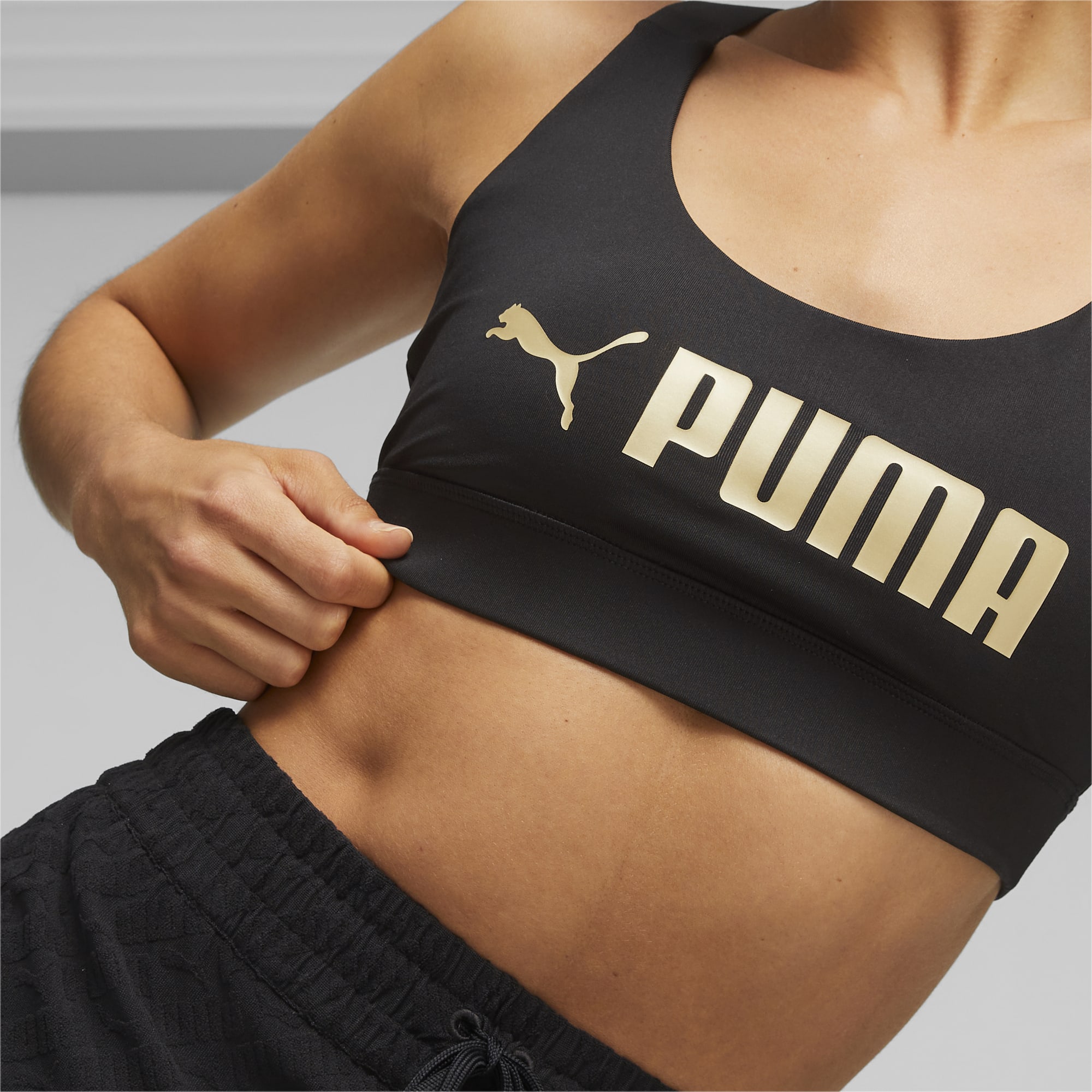 PUMA Fit Mid Support Trainings-BH Damen, Schwarz/Gold, Größe: XXS