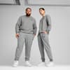 Two models pose in grey sweatshirts and trousers against a grey backdrop.