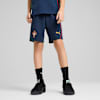 On grey, a child models navy shorts with Portugal's emblem, paired with black socks and shoes.