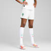 Against grey, a model is wearing white kit, socks with logo and running shoes.