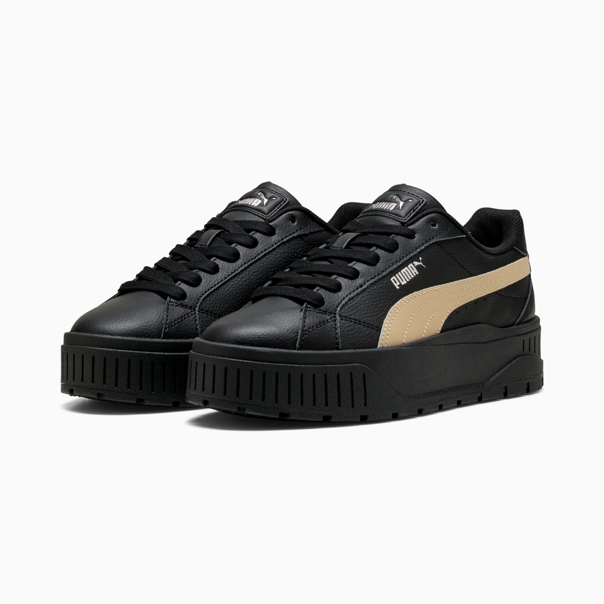 Sneakers PUMA nere da adulto con striscia laterale beige e suola platform.