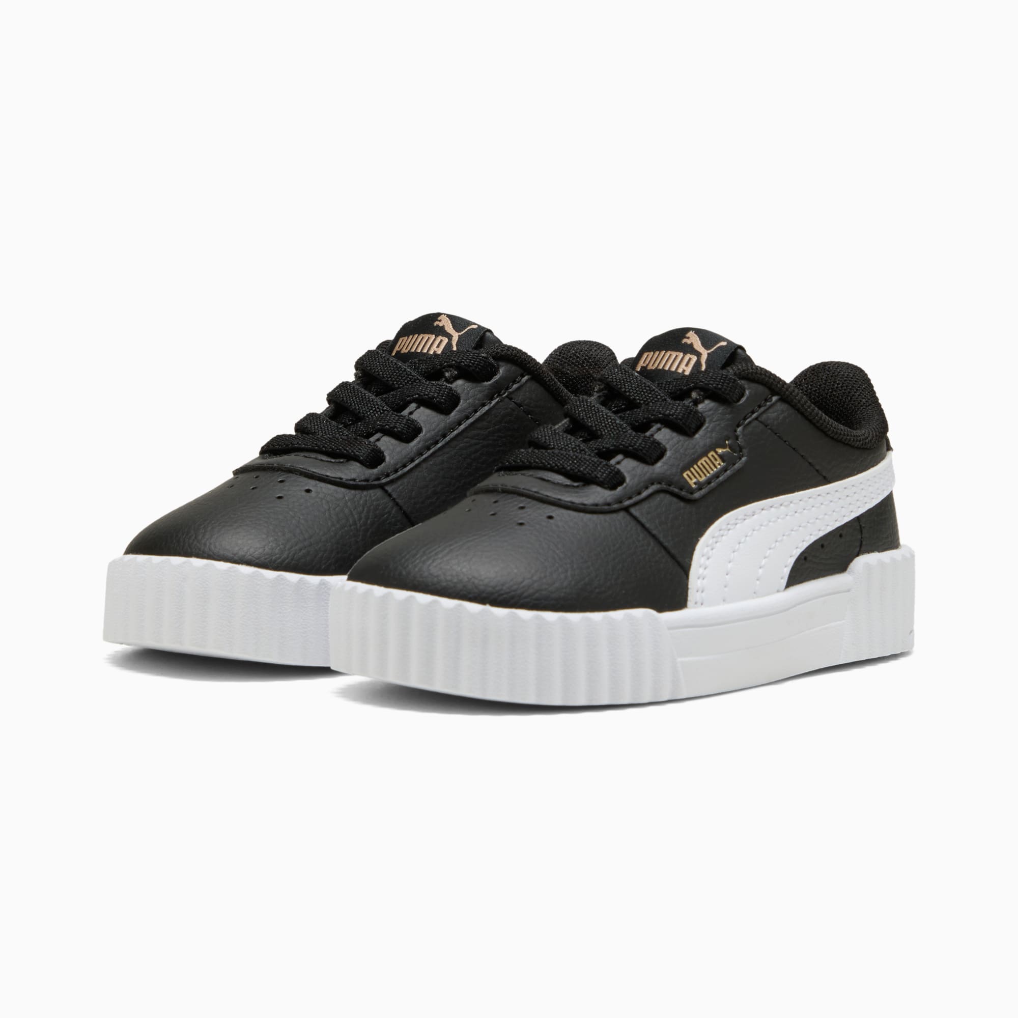 Schwarze PUMA Turnschuhe für Kinder, mit weißem Streifen und Schnürverschluss.