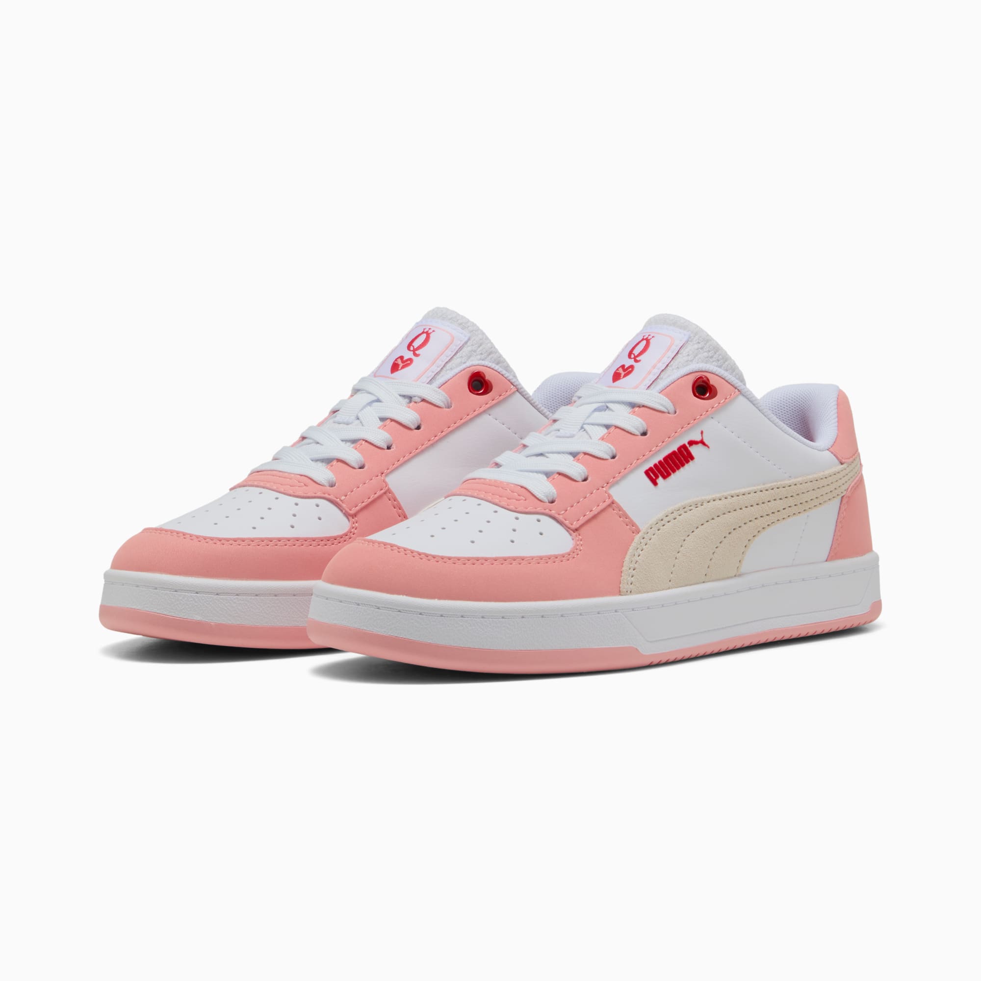 Pink and white PUMA trainers for youth, featuring lace-up closure and logo detail.