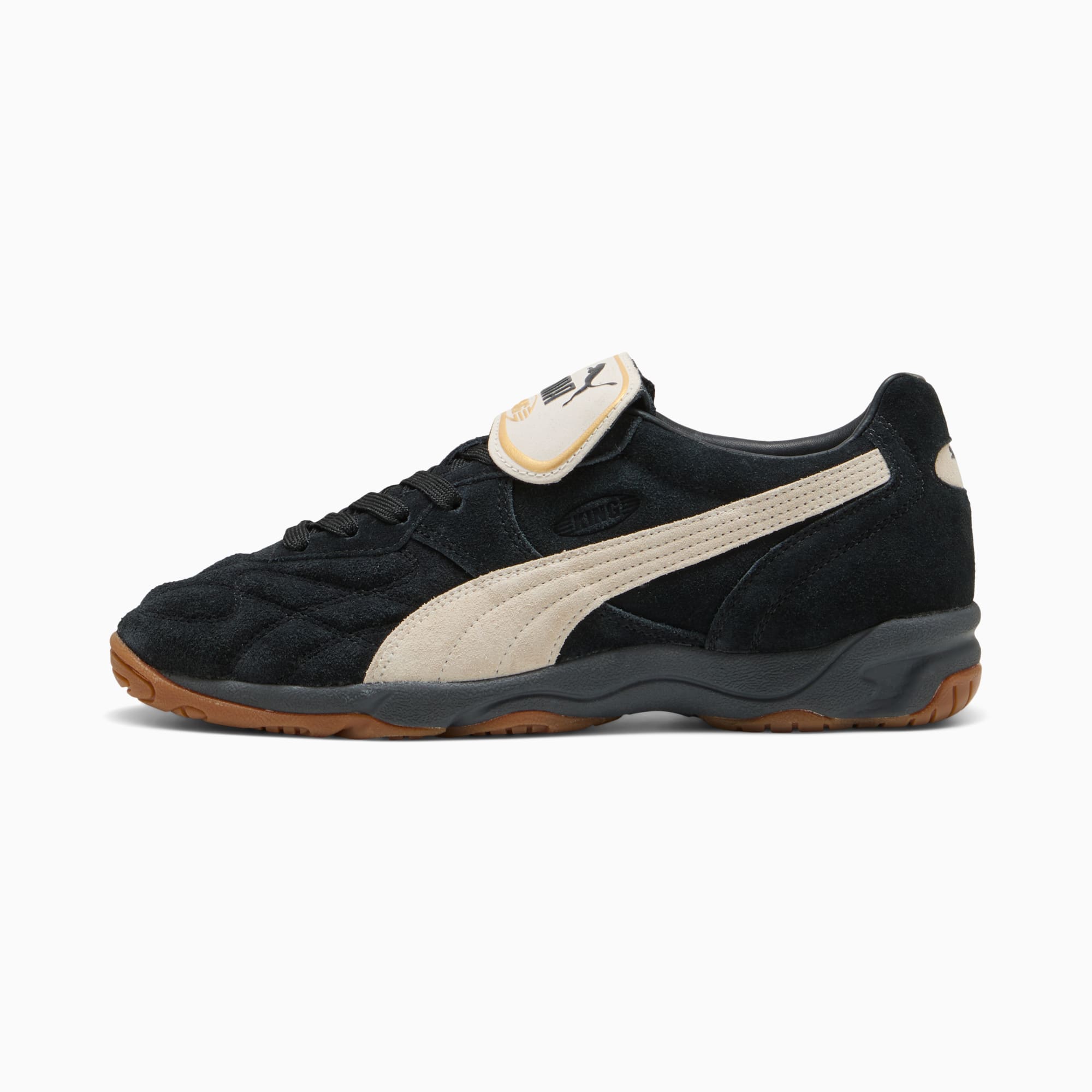 Scarpa da ginnastica PUMA nera con striscia e linguetta color crema e suola marrone.