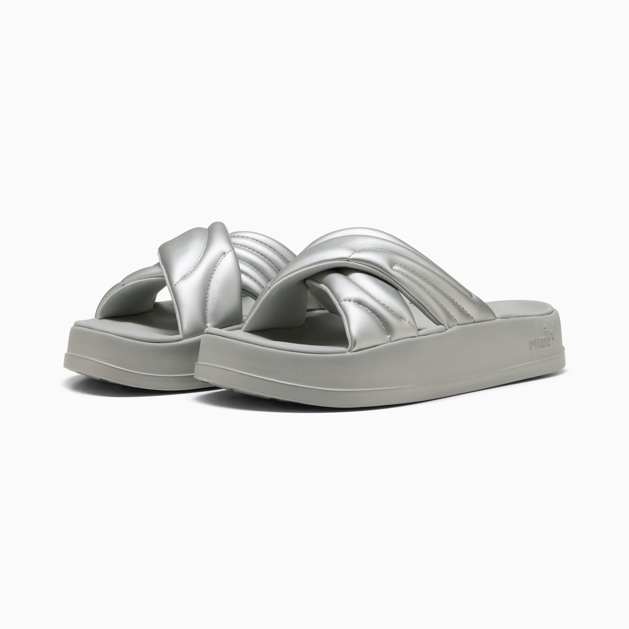 Silver PUMA slides for women with a padded, criss-cross strap design on a platform sole.