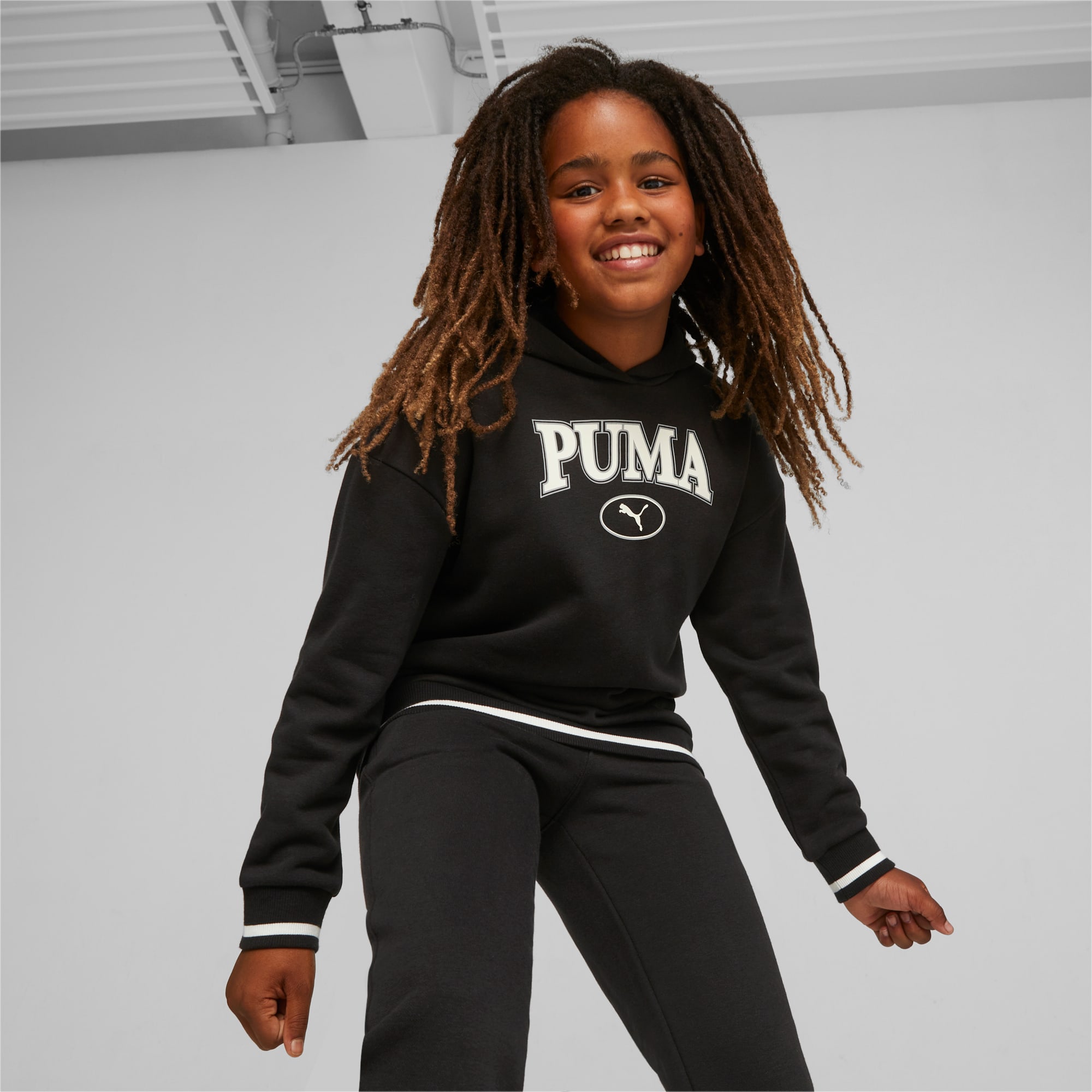 Girl in sweatpants and hoodie. Trendy sportswear. Sport style