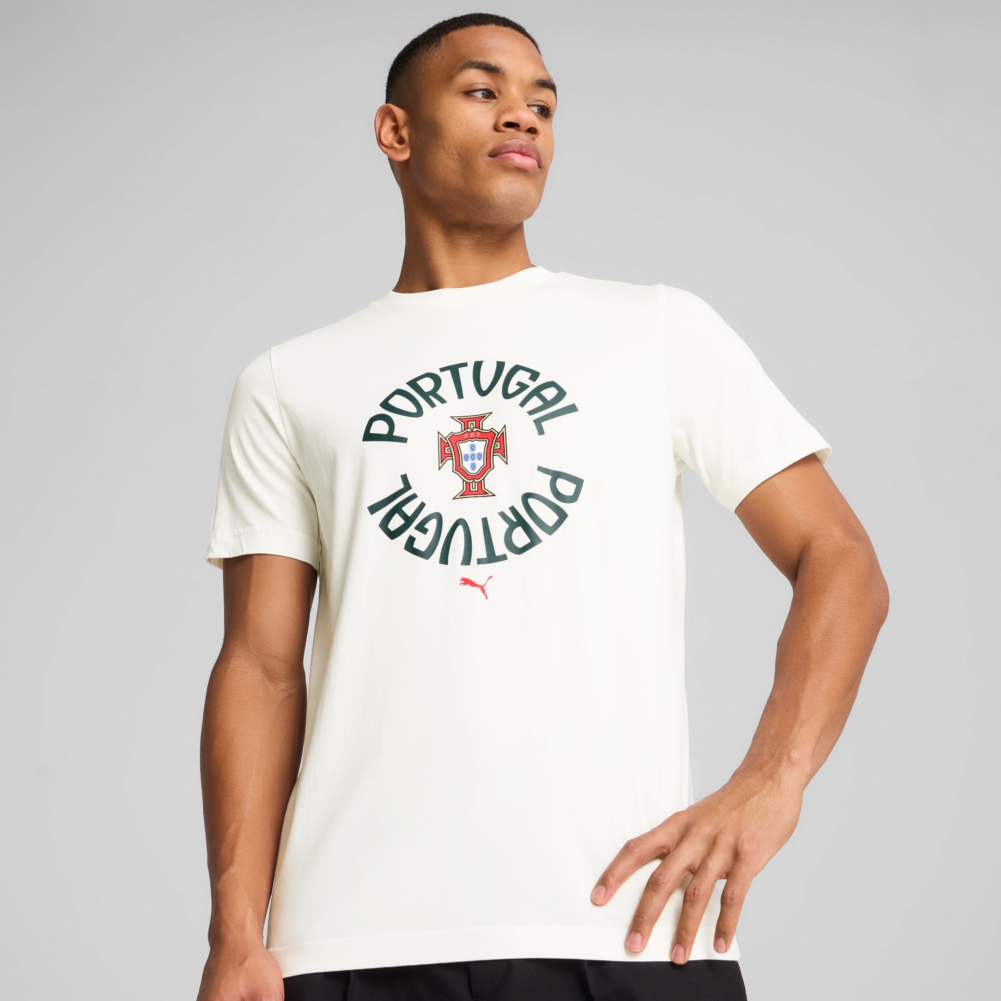 A model poses against a grey background, wearing a white t-shirt with a Portugal logo.