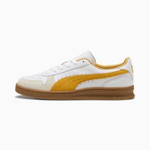 White PUMA trainers for adults, featuring gold accents and a brown sole.