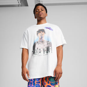 A model stands against a grey background wearing a graphic t-shirt and patterned shorts.