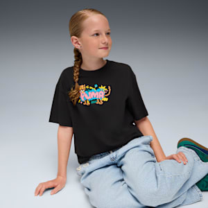 A model sits on a grey background wearing a black tee with a colourful print.