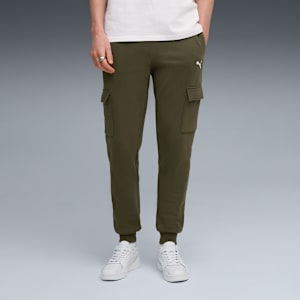 A model stands on grey wearing olive cargo trousers and white trainers.