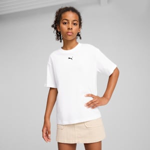 A model poses against grey, wearing a white t-shirt and a beige skirt.