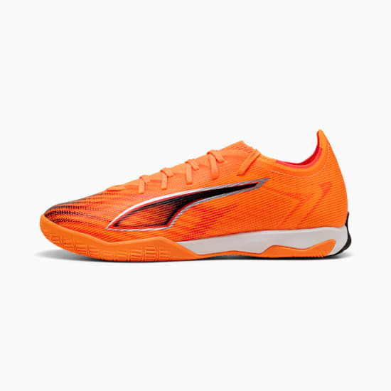 Orange PUMA football trainers with a textured upper and black logo detail.
