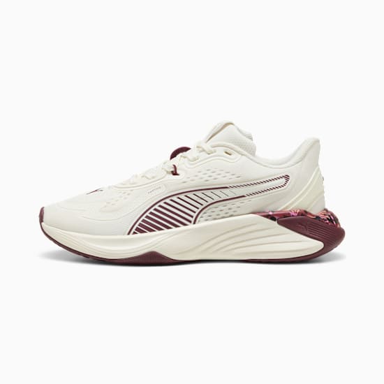 Cream PUMA women's trainer with burgundy stripes and floral heel detail.