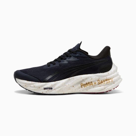 Navy PUMA running shoe, adult size, with a speckled, sculpted white sole and black laces.