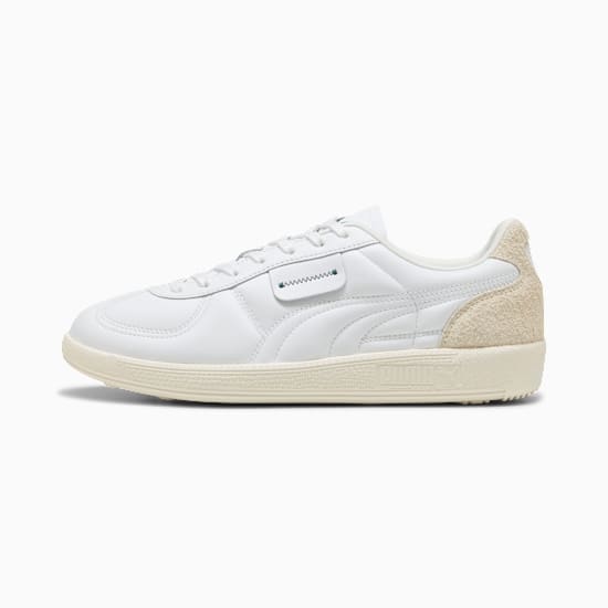 White PUMA trainers with textured heel and stitched detailing for adults.