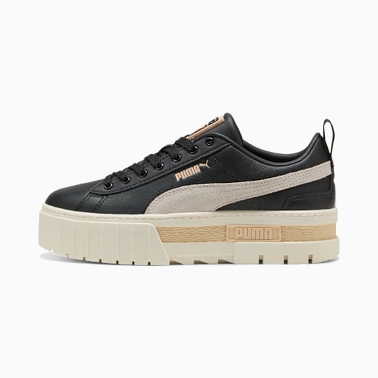 Black PUMA women's trainer with a thick, beige platform sole and side stripe.