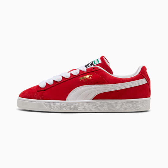 Red PUMA trainers for adults, featuring white laces and a signature side stripe.