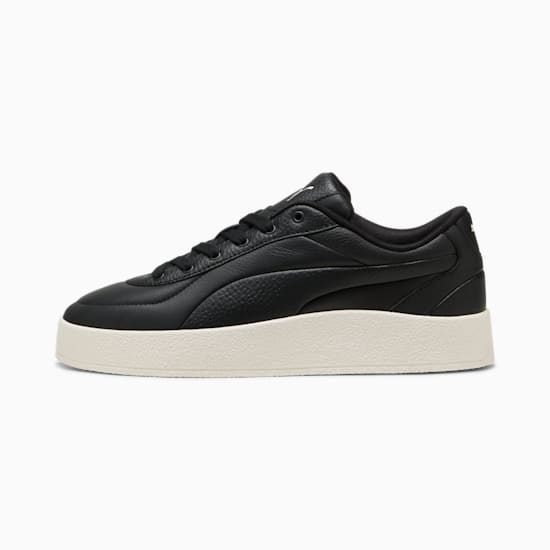 Black PUMA women's trainer with textured upper and off-white platform sole.
