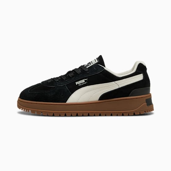 Black PUMA Palermo men's trainer with a white stripe and brown ridged sole.