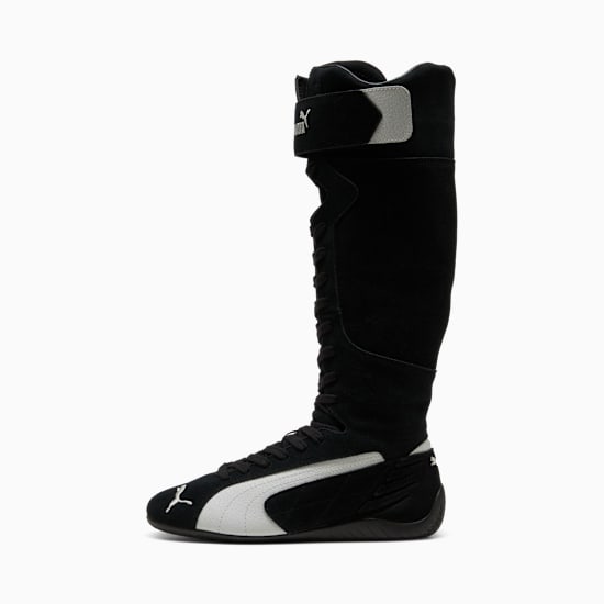 Black PUMA boot with a high shaft, laces, a side stripe, and an adjustable strap.