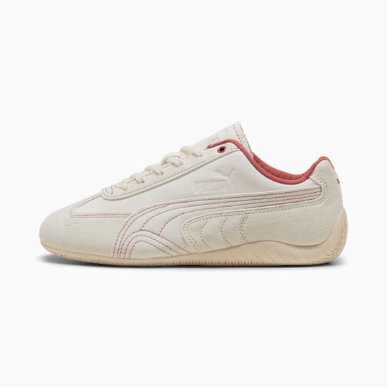 Cream PUMA trainer with red stitching and suede detailing, for adults.