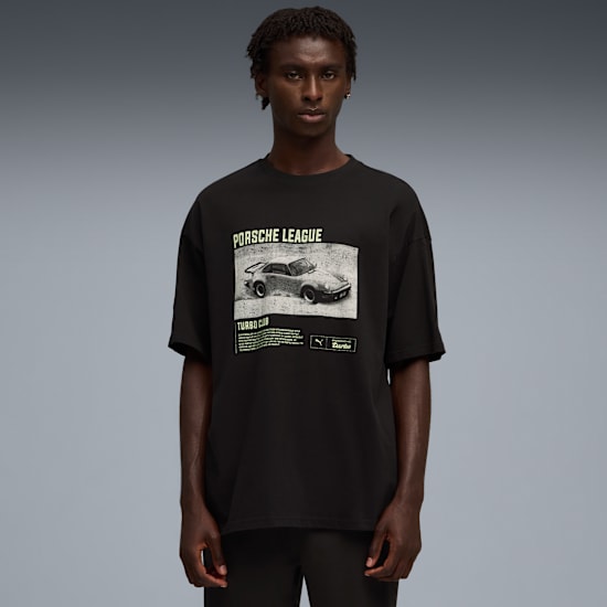 A model stands against a grey backdrop, wearing a black t-shirt with a car graphic.