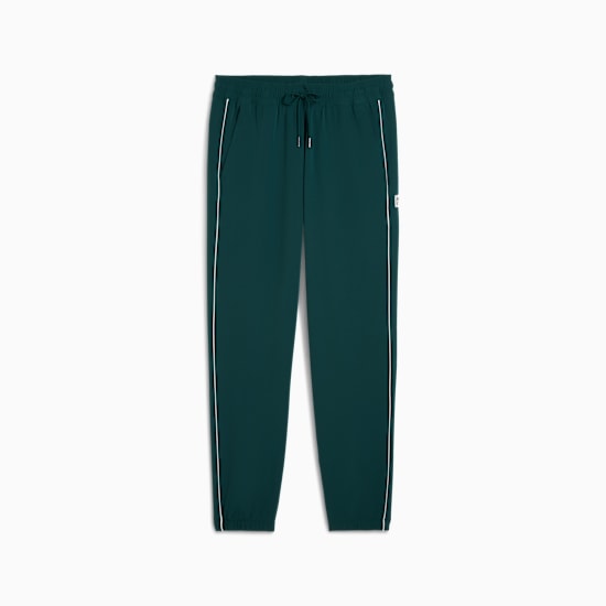 Green PUMA trousers with white side stripes for adults.
