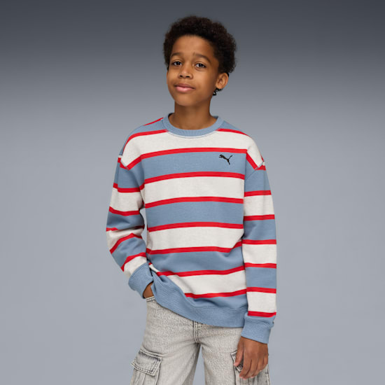 A model against grey wears a striped sweatshirt and light grey shorts.