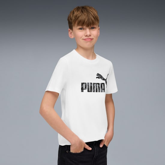 A model poses against a grey backdrop, wearing a white t-shirt with a PUMA logo.