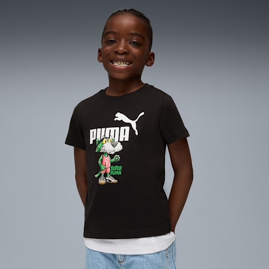 A smiling child in front of grey backdrop wears a black t-shirt with a Puma graphic.