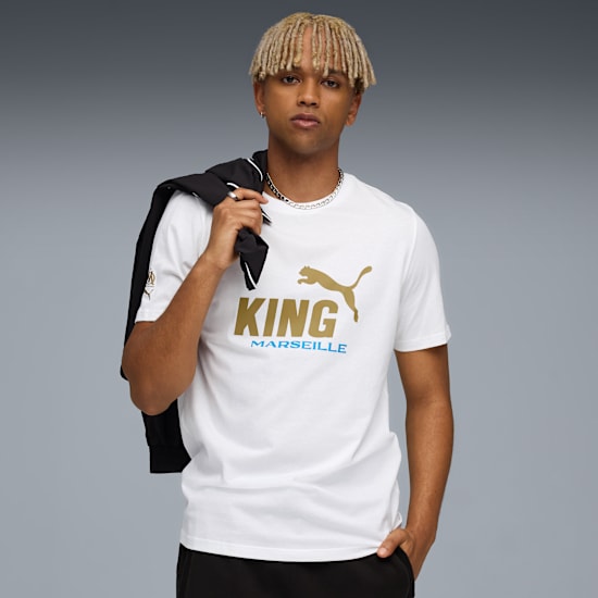 Against grey, a model wears a white tee with gold 'KING' and a jacket.