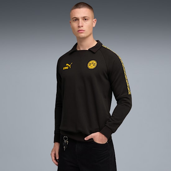 A model poses against grey, wearing a black long-sleeved top with yellow BVB logo.