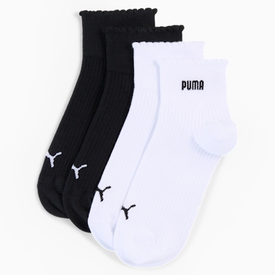 Black and white PUMA socks for adults, with ribbed cuffs and logo detail.