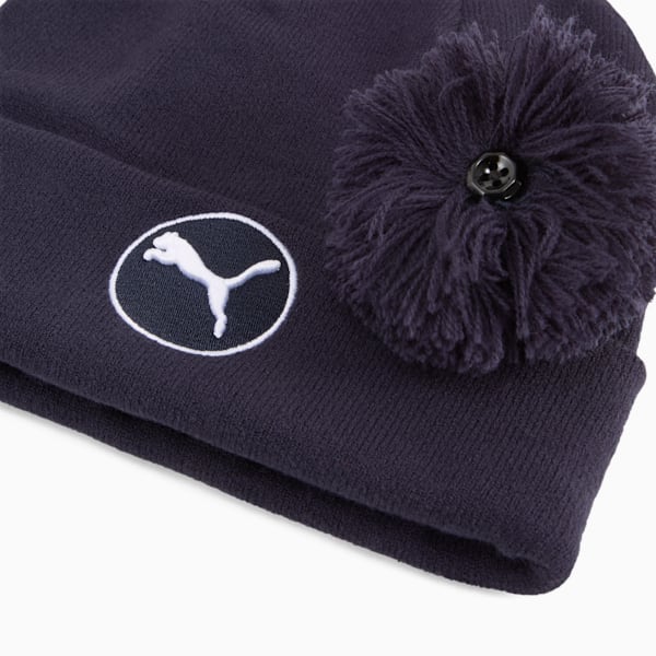 Navy PUMA beanie with pompom and logo detail.