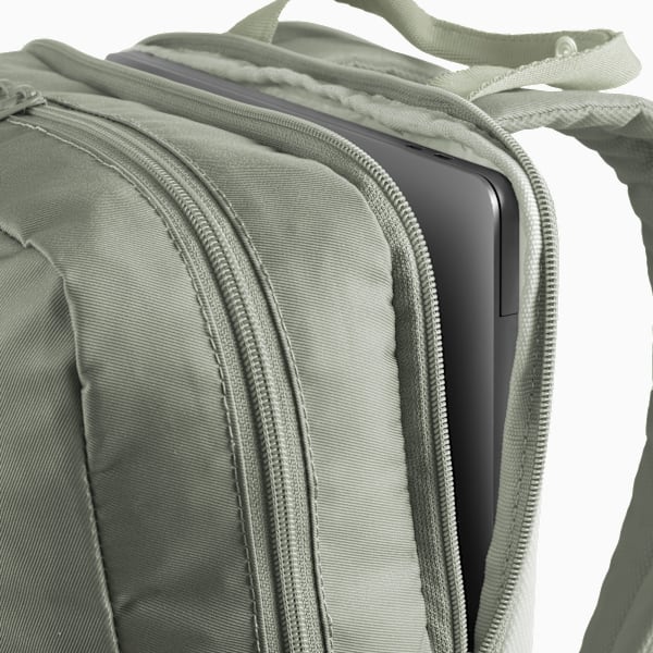 Sage PUMA rucksack, partially unzipped, reveals a laptop inside.