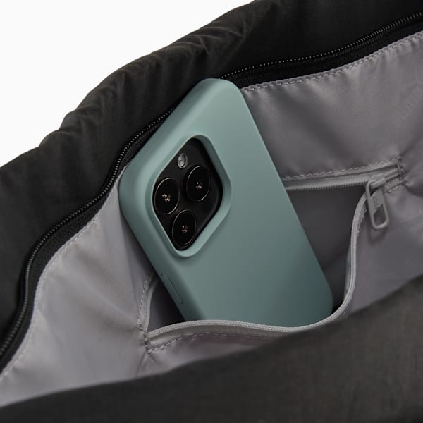 Black PUMA bag interior with a light-blue phone in a pocket with a zipper.