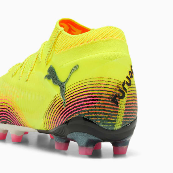 Yellow PUMA football boot showing the back with pink and black graphic details.