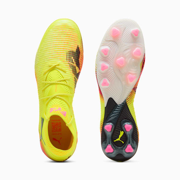 Yellow PUMA football boots with a textured upper and pink stud detailing on the sole.