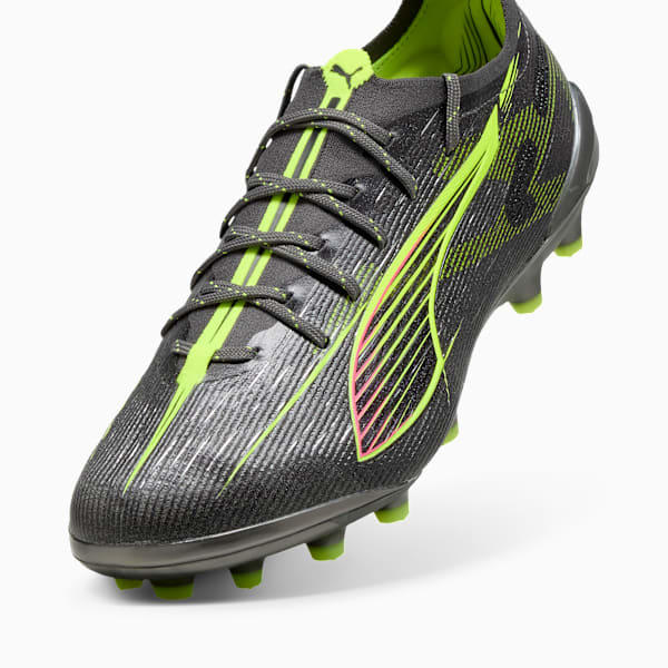 Grey PUMA football boot with neon green accents and a textured upper.