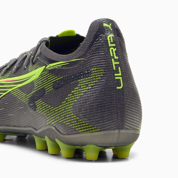 Grey PUMA football boot featuring neon green details and stud cleats.