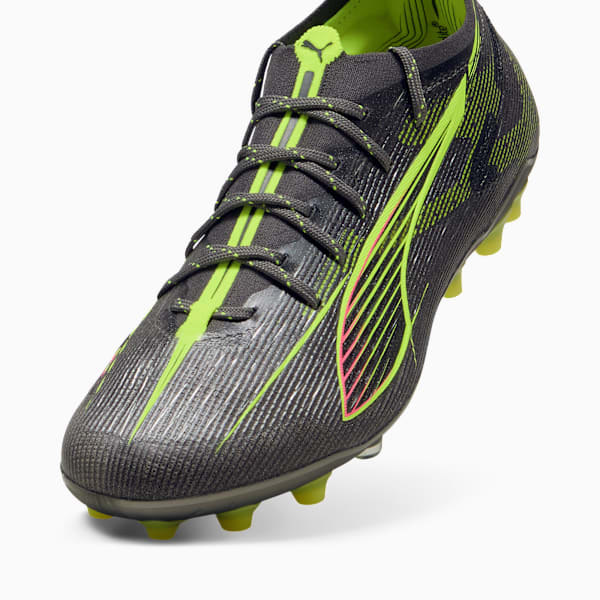 Grey PUMA football boot with neon green and pink details, and a lace-up closure.