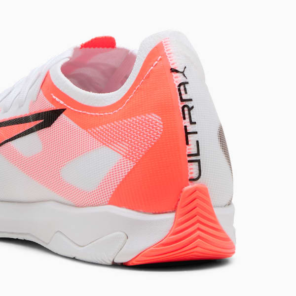 White PUMA trainers feature coral accents and the word 'ULTRA' printed on the side.