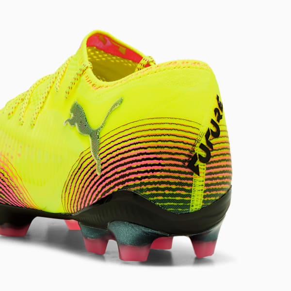 Yellow PUMA football boot with black and pink striped heel detail.