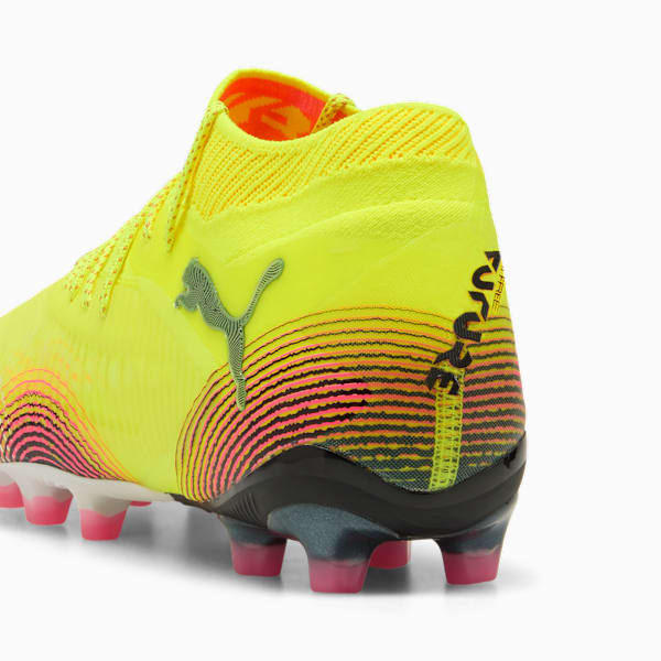 Yellow PUMA football boot featuring black and pink stripes, and stud details.
