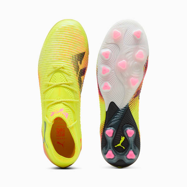 Yellow PUMA football boots with a textured upper and pink stud detailing.