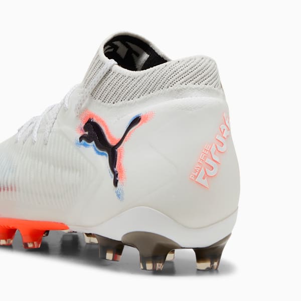 White PUMA football boot with a black logo, orange details and 'FUTURE' text.