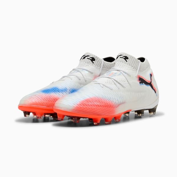 White PUMA football boots with red/blue accents, laces, and a black logo on the side.