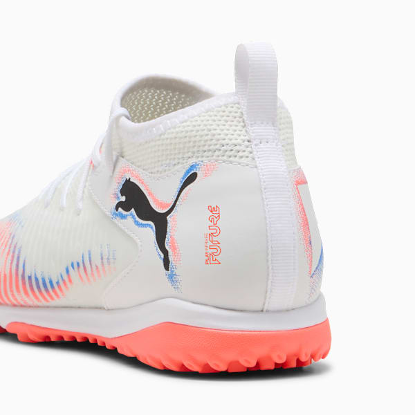 White PUMA football boot with black logo and coral sole.