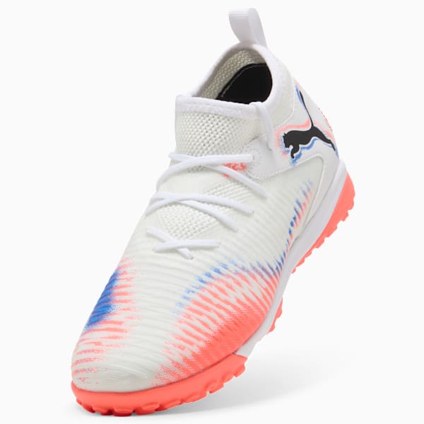 White PUMA football boot with coral and blue accents, and lace-up fastening.